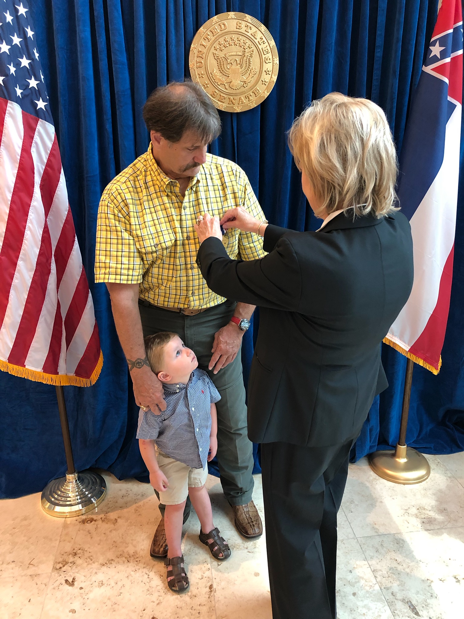 Jay Blount of Greenville and grandson Sutton.  Defense of Freedom Medal