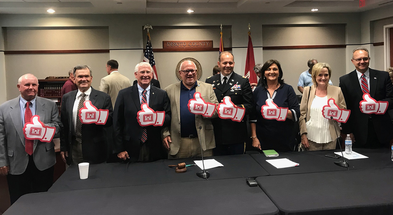 Senator Hyde-Smith joins in a thumbs-up salute for a DeSoto County-Army Corps flood control agreement
