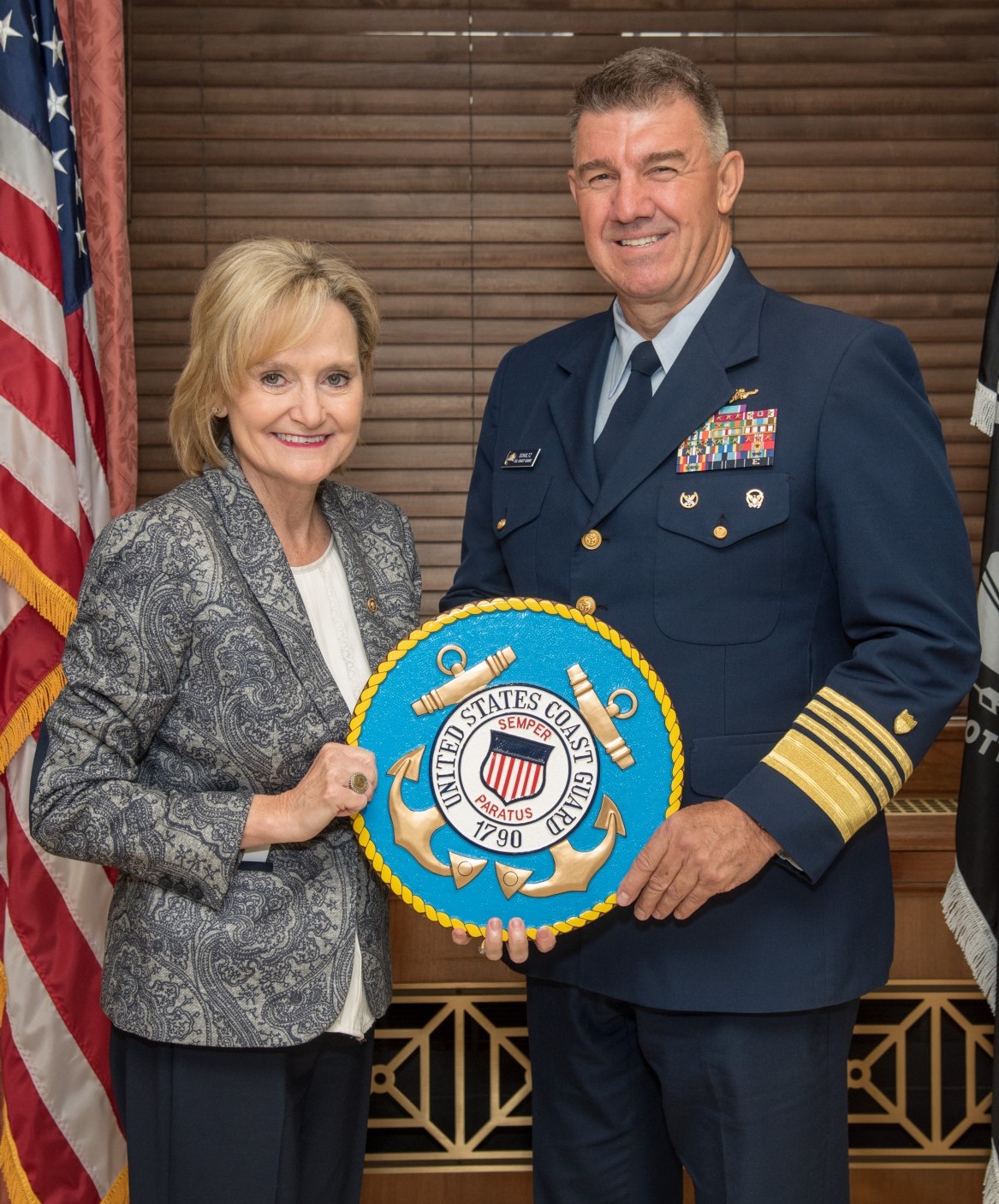 Senator Hyde-Smith accepts a U.S. Coast Guard seal from Admiral Karl L. Schultz, Coast Guard Commandant